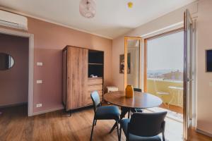 a dining room with a table and chairs and a window at My Tuscany Pink Suite in San Quirico dʼOrcia