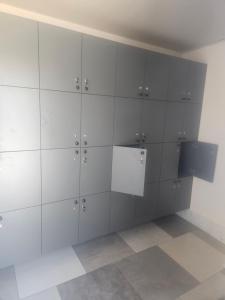 a locker room with white cabinets in a room at NectaraVilla PooL in Ashtarak
