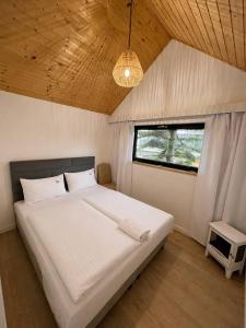 a bedroom with a large white bed with a window at Villa Promenada in Międzyzdroje +46 photos