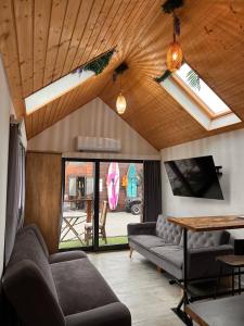 a living room with couches and a wooden ceiling at Villa Promenada in Międzyzdroje