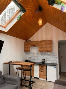 an attic kitchen with a table and a counter at Villa Promenada in Międzyzdroje