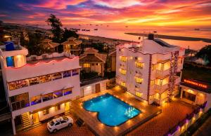 an aerial view of a building with a swimming pool at Blooming Star in Mandarmoni