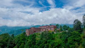 a building on the side of a hill with trees at Landmark Diamond Hill in Panaoti