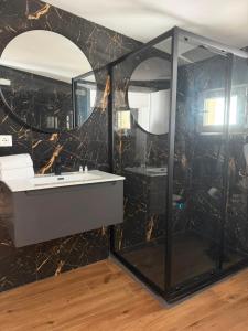 a bathroom with a sink and a mirror at Leonida Residence in Taranto +32 photos