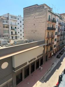 a building on a city street with buildings at Leonida Residence in Taranto