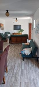a living room with a couch and a piano at apartman Marina in Sutivan