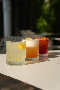 three cocktails sitting on top of a table at Villa Pontica in Mamaia Sat/Năvodari