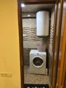 a small bathroom with a washing machine and a washing machine at Villa hills II in Yerevan +4 photos