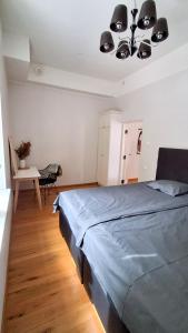 a bedroom with a large bed and a table at Lossi 32 Lux Apartment in Tartu