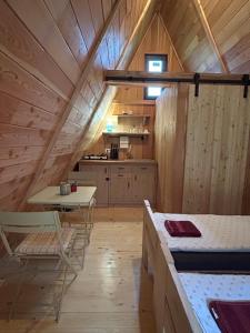 a room with a bed and a table and a kitchen at Glamping cabins in Gorenja Vas +28 photos