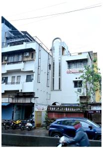a man riding a motorcycle in front of a building at MTDC Shivtej in Kolhapur