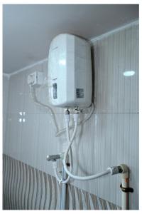 a white tank on the wall of a bathroom at MTDC Shivtej in Kolhapur +29 photos