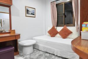 a small bedroom with a bed and a window at Khun Ying House in Ko Tao +18 photos