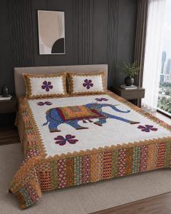 a bed with a colorful quilt on it in a bedroom at Hotel Lomontreey in Kākori