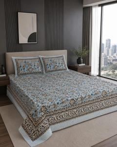 a large bed in a bedroom with a large window at Hotel Lomontreey in Kākori