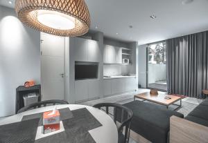 a living room with a table and a couch at HARRIS Hotel & Conventions Malang in Malang
