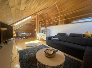 a living room with a couch and a table at Chalet Notschkerl in Waasen