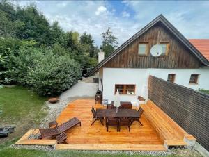a wooden deck with a table and chairs in front of a house at Chalet Notschkerl in Waasen