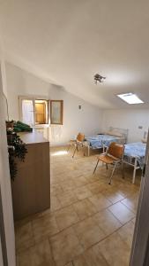 a room with a kitchen and a table and chairs at Nonna Marisa B&B in Madonna di Fornelli +9 photos