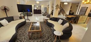 a living room with two couches and a tv at Private Villa Sea View 5BR in Ain Sokhna