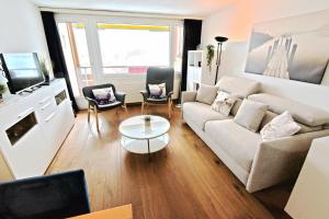 a living room with a couch and a table at Tgesa Sunnmatt 24 in Savognin