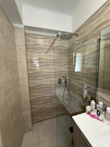 a bathroom with a shower and a sink at Makis & Lena's Home in Svoronata +32 photos