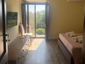 a bedroom with a bed and a door to a balcony at La Sorgente Alta in Rocchetta a Volturno
