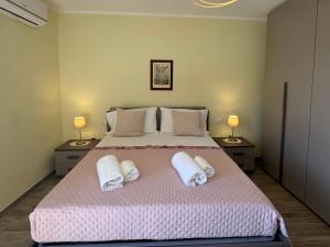 a bedroom with a large bed with towels on it at La Sorgente Alta in Rocchetta a Volturno