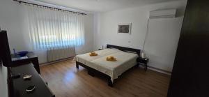 a bedroom with a bed with two towels on it at Kuća za odmor BARSON in Vukovar