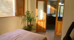 a bedroom with a potted plant next to a door at Casa luz Vista Verde Appartment in Polopos
