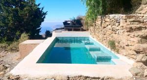a swimming pool on top of a stone wall at Casa luz Vista Verde Appartment in Polopos +9 photos
