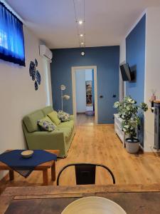 a living room with a couch and a table at The Blue Gem in Acqui Terme