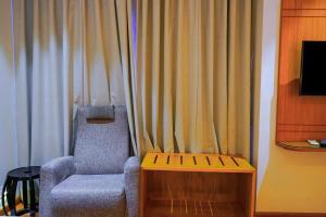 a chair sitting in front of a curtain at Middleton Inn in Kolkata +8 photos