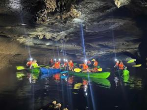 a group of people in kayaks in a cave at Vietnam Venture Cruises in Cat Ba