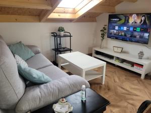 a living room with a couch and a flat screen tv at Vaniria 4 Apartamentos Nuevos in Foz