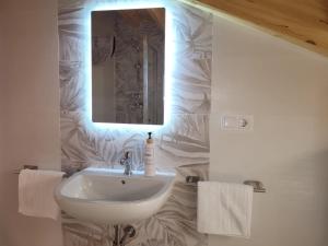 a bathroom with a sink and a mirror at Vaniria 4 Apartamentos Nuevos in Foz +68 photos