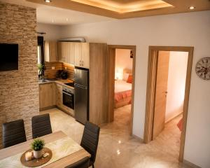 a kitchen and dining room with a table and a bed at Chrisella Villa in Skala Rachoniou