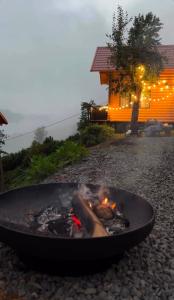 a fire pit in a yard next to a house at OHANA Cottages in Merisi in Merisi