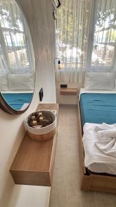 a small room with a bed and a mirror at Minikbiotel in Erdek