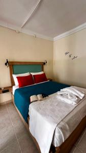 a bedroom with a large bed with red pillows at Minikbiotel in Erdek +5 photos