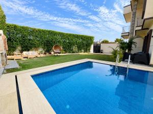 a swimming pool in the backyard of a house at La Dolce Villa with Private Pool in Borg El Arab
