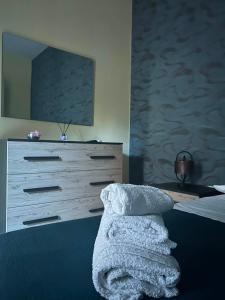 a bedroom with a dresser and a bed with a blanket at Alla Chiesetta in Naples