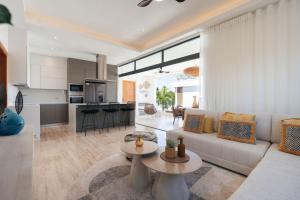 a living room with a couch and a table at Sol de Arena Beachfront Condos by Bocobay in Las Terrenas