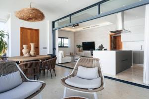 a kitchen and living room with a table and chairs at Sol de Arena Beachfront Condos by Bocobay in Las Terrenas +49 photos