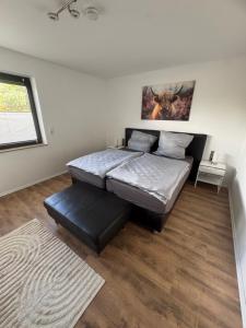 a bedroom with a large bed and a window at HabichtsNest Stockum in Sundern
