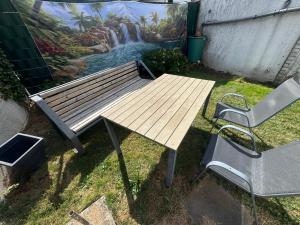 a picnic table and a chair next to a mural at HabichtsNest Stockum in Sundern