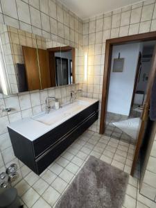 a bathroom with a sink and a mirror at HabichtsNest Stockum in Sundern +5 photos