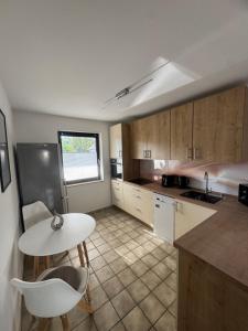 a kitchen with a table and a white table and chairs at HabichtsNest Stockum in Sundern