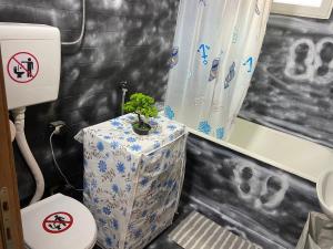 a bathroom with a toilet and a plant on a table at Stojanovski Apartments in Kumanovo +38 photos
