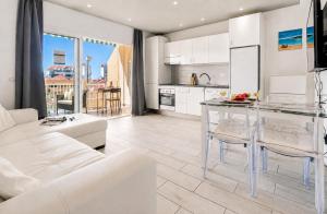 a white kitchen and living room with a glass table at Cosy Mareverde FREE WIFI by Olax Rentals in Adeje